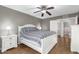 Comfortable main bedroom features a ceiling fan, neutral walls, and wood-look tile flooring at 2315 W Union Hills Dr # 124, Phoenix, AZ 85027