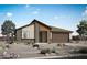 Stunning single-story home featuring a modern design, desert landscaping, and attached two-car garage at 25727 N 147Th Dr, Surprise, AZ 85387
