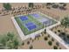 Aerial view of community pickleball courts with green and blue playing surfaces and surrounding landscaping at 25727 N 147Th Dr, Surprise, AZ 85387