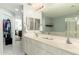 Bathroom with double sinks, vanity with white cabinets and a large mirror at 33550 N Dove Lakes Dr # 1041, Cave Creek, AZ 85331