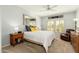 Comfortable bedroom featuring a plush bed, ceiling fan, and ample natural light from two bright windows at 33550 N Dove Lakes Dr # 1041, Cave Creek, AZ 85331