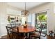 Cozy dining area featuring a copper table, decorative chandelier, and sliding door to the outdoor patio at 33550 N Dove Lakes Dr # 1041, Cave Creek, AZ 85331