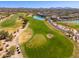 Picturesque aerial view of a golf course featuring lush greenery, lakes, and desert landscaping at 33550 N Dove Lakes Dr # 1041, Cave Creek, AZ 85331