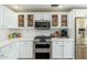 Well-appointed kitchen featuring glass-front cabinets and modern stainless steel appliances and finishes at 33550 N Dove Lakes Dr # 1041, Cave Creek, AZ 85331