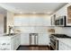 Bright kitchen featuring white cabinetry, stainless steel appliances, and a garden window for natural light at 33550 N Dove Lakes Dr # 1041, Cave Creek, AZ 85331