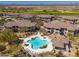Aerial view of resort-style community pool and lounge area surrounded by lush landscaping and desert views at 33550 N Dove Lakes Dr # 1041, Cave Creek, AZ 85331