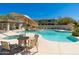 Community pool with hot tub, seating and covered outdoor kitchen area at 33550 N Dove Lakes Dr # 1041, Cave Creek, AZ 85331