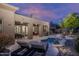 Luxurious backyard featuring a pool, lounging area, fire pit, and outdoor kitchen, perfect for entertaining at 33601 N 64Th St, Scottsdale, AZ 85266