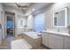 Luxurious bathroom featuring double vanities, a soaking tub, and stylish tile work at 33601 N 64Th St, Scottsdale, AZ 85266