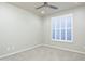 Neutral bedroom featuring modern ceiling fan, carpeted floors, and plantation shutters allowing lots of natural light at 33601 N 64Th St, Scottsdale, AZ 85266