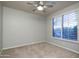 Neutral bedroom featuring modern ceiling fan, carpeted floors, and plantation shutters allowing lots of natural light at 33601 N 64Th St, Scottsdale, AZ 85266