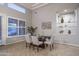 Elegant dining room with a modern table, comfortable chairs, and built-in display shelves at 33601 N 64Th St, Scottsdale, AZ 85266