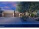 Attractive home exterior with a well-manicured yard, mature tree, and a three-car garage at 33601 N 64Th St, Scottsdale, AZ 85266