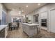 Spacious kitchen featuring a center island with seating, stainless steel oven, and a dining area at 33601 N 64Th St, Scottsdale, AZ 85266