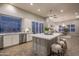 Bright kitchen with white cabinets, stainless steel appliances, and a large center island with seating at 33601 N 64Th St, Scottsdale, AZ 85266