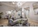Inviting living room featuring a modern gray sofa, striking light fixture, and elegant decor at 33601 N 64Th St, Scottsdale, AZ 85266