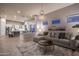 Bright living room featuring a gray sectional, chandelier, and an open view into the adjacent kitchen at 33601 N 64Th St, Scottsdale, AZ 85266