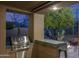 Outdoor kitchen with a built-in grill and bar area, perfect for entertaining in the landscaped backyard at 33601 N 64Th St, Scottsdale, AZ 85266