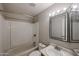 Bathroom includes a shower-tub combo, single sink vanity, and framed mirror with lighting at 3646 N 69Th Ave # 4, Phoenix, AZ 85033