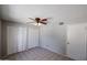 This bedroom features a ceiling fan, closet space and a door at 3646 N 69Th Ave # 4, Phoenix, AZ 85033