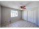 Spacious bedroom with a ceiling fan, tile flooring, and closet space at 3646 N 69Th Ave # 4, Phoenix, AZ 85033