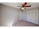 Bedroom featuring tile flooring, a ceiling fan and a closet at 3646 N 69Th Ave # 4, Phoenix, AZ 85033