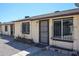 Exterior view of home with security door, gravel landscaping, and barred windows at 3646 N 69Th Ave # 4, Phoenix, AZ 85033