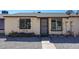 Exterior of a tan home featuring a security door, rock landscaping, and window bars at 3646 N 69Th Ave # 4, Phoenix, AZ 85033