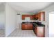 Updated kitchen with cherry cabinets, black appliances, and tile flooring at 3646 N 69Th Ave # 4, Phoenix, AZ 85033