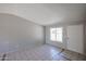 Bright living room featuring neutral walls, tile flooring and a large window for natural light at 3646 N 69Th Ave # 4, Phoenix, AZ 85033