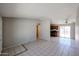 View of the open living room with tile floors flowing into the kitchen at 3646 N 69Th Ave # 4, Phoenix, AZ 85033