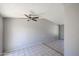 Open living room featuring tile floors, gray walls and a ceiling fan at 3646 N 69Th Ave # 4, Phoenix, AZ 85033