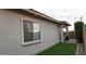 Manicured backyard featuring artificial turf and stylish outdoor string lights at 4090 S Virginia Way, Chandler, AZ 85249