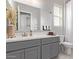 Bright bathroom featuring a gray vanity with a white countertop, neutral walls, and a large mirror at 4090 S Virginia Way, Chandler, AZ 85249