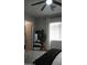 Neutral bedroom features a ceiling fan, window, doorway, full length mirror, and cozy, chunky knit blanket on the bed at 4090 S Virginia Way, Chandler, AZ 85249