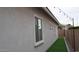 Side of house with artificial turf, block wall, and exterior lighting at 4090 S Virginia Way, Chandler, AZ 85249