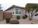 Home featuring gray stone accents, brick wall, and manicured landscaping at 4090 S Virginia Way, Chandler, AZ 85249