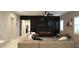 Open-concept living room featuring dark accent wall with fireplace and light floors at 4090 S Virginia Way, Chandler, AZ 85249