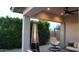 Relaxing outdoor patio with a modern heater, hanging chair, and lush greenery backdrop at 4090 S Virginia Way, Chandler, AZ 85249