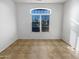 Bright empty bedroom featuring a window with shutter blinds and tiled flooring at 41220 N Belfair Way, Anthem, AZ 85086