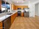 Well-lit kitchen equipped with stainless steel appliances, wooden cabinets, and white countertops at 41220 N Belfair Way, Anthem, AZ 85086
