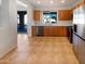Well-lit kitchen with stainless steel appliances, wood cabinets, and a view of the outdoor patio at 41220 N Belfair Way, Anthem, AZ 85086