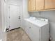 Convenient laundry room with washer, dryer, and storage cabinets for efficient organization at 41220 N Belfair Way, Anthem, AZ 85086