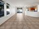 Spacious living area with tiled floors, big windows, and seamless flow into the kitchen and backyard at 41220 N Belfair Way, Anthem, AZ 85086