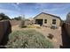 Fenced backyard with gravel, shrubs and a covered patio at 4729 E Chromium Rd, San Tan Valley, AZ 85143