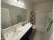 Bathroom boasts a large mirror, vanity with solid countertop, and shower-tub combo at 4729 E Chromium Rd, San Tan Valley, AZ 85143