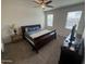 Cozy bedroom featuring a ceiling fan, two windows, and a comfortable bed with side tables at 4729 E Chromium Rd, San Tan Valley, AZ 85143