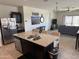 Open-concept kitchen and living area featuring a large island, granite counters, and stainless appliances at 4729 E Chromium Rd, San Tan Valley, AZ 85143