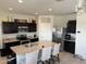 Modern kitchen featuring an island with seating, stainless steel appliances, and granite countertops at 4729 E Chromium Rd, San Tan Valley, AZ 85143