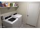 Laundry room with white washer and dryer and storage shelves at 4729 E Chromium Rd, San Tan Valley, AZ 85143